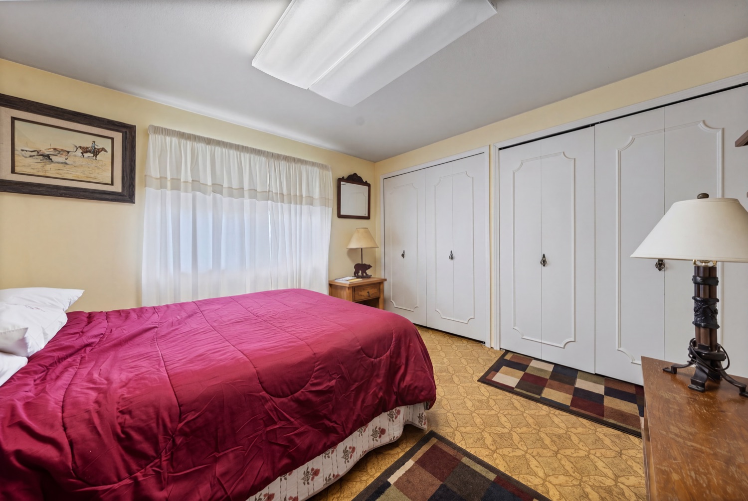 Second bedroom with ceiling fan and natural light