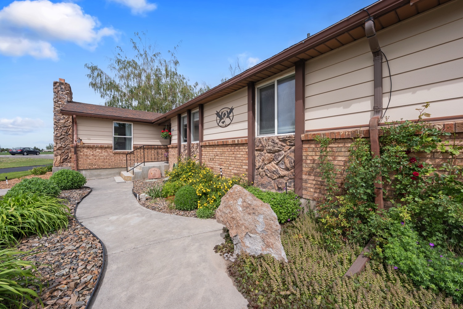 Landscaped walkway and brick-and-stone front exterior of 2224 E Highway 33
