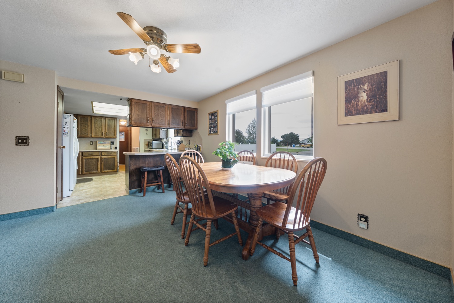 Dining area open to the kitchen with large windows