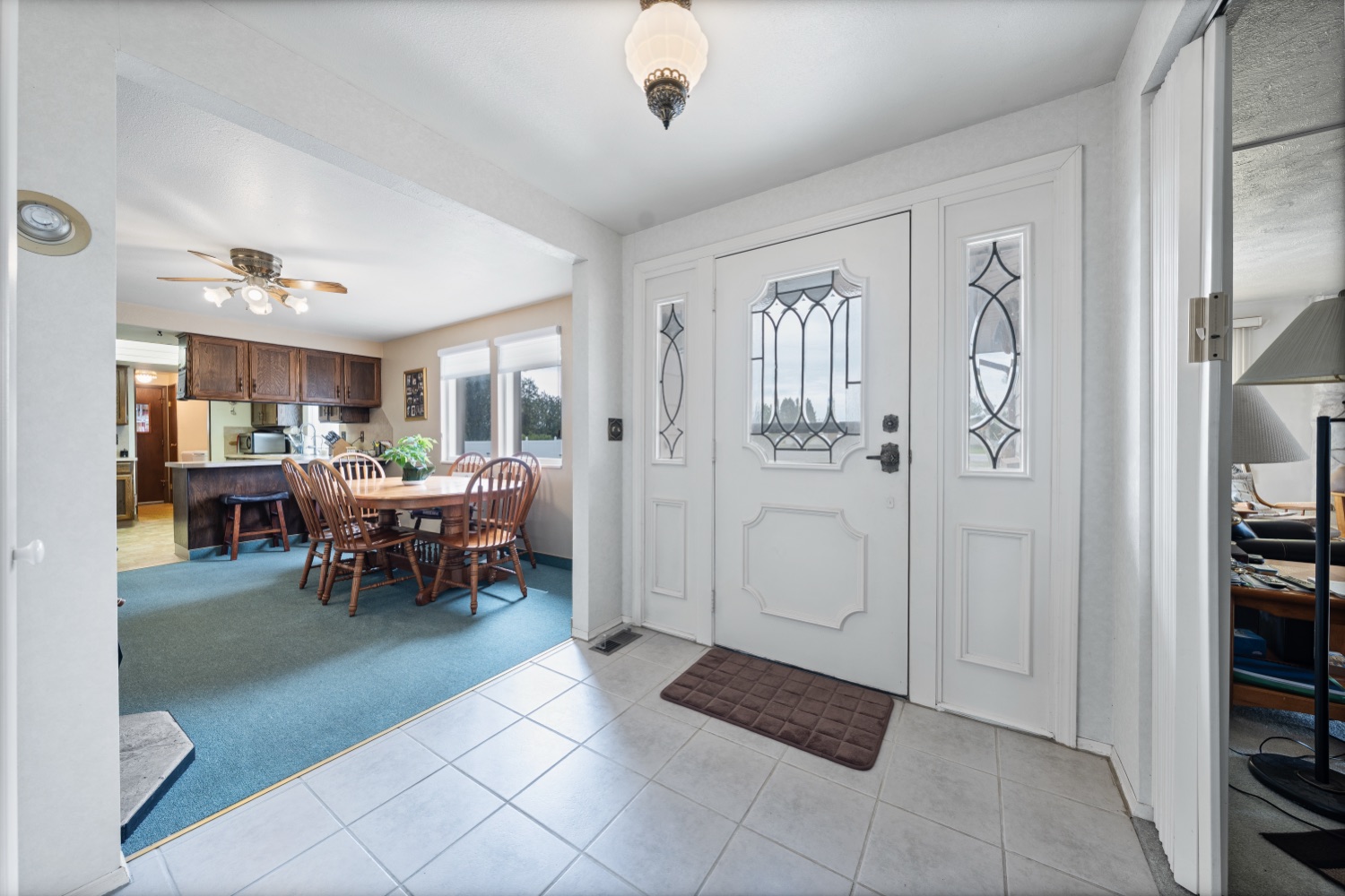 Tiled foyer with double doors opening into the living and dining area
