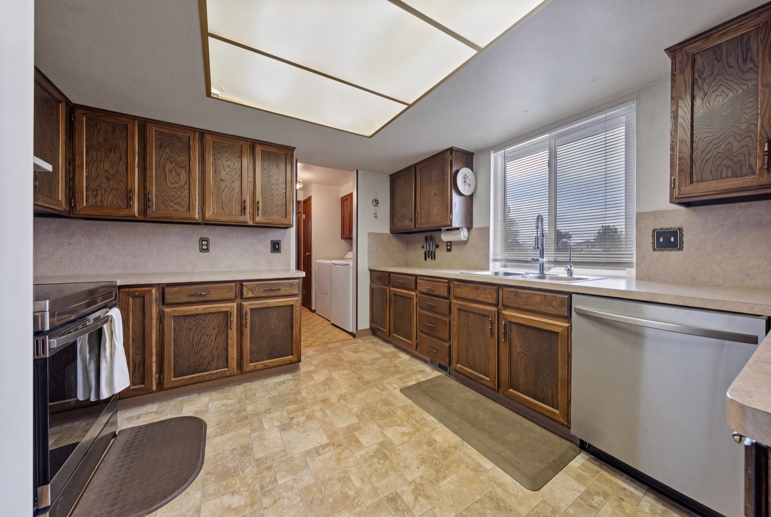Kitchen with window over sink and dishwasher