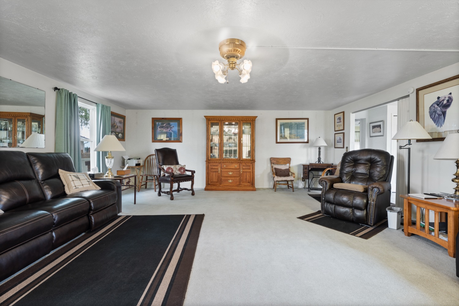 Living room with antique hutch and abundant natural light