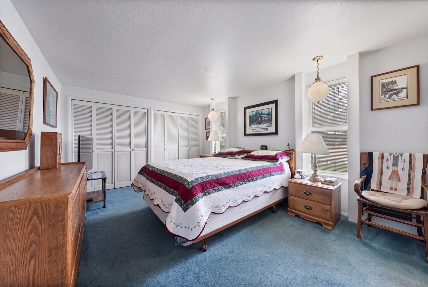 Primary bedroom with wall of closets
