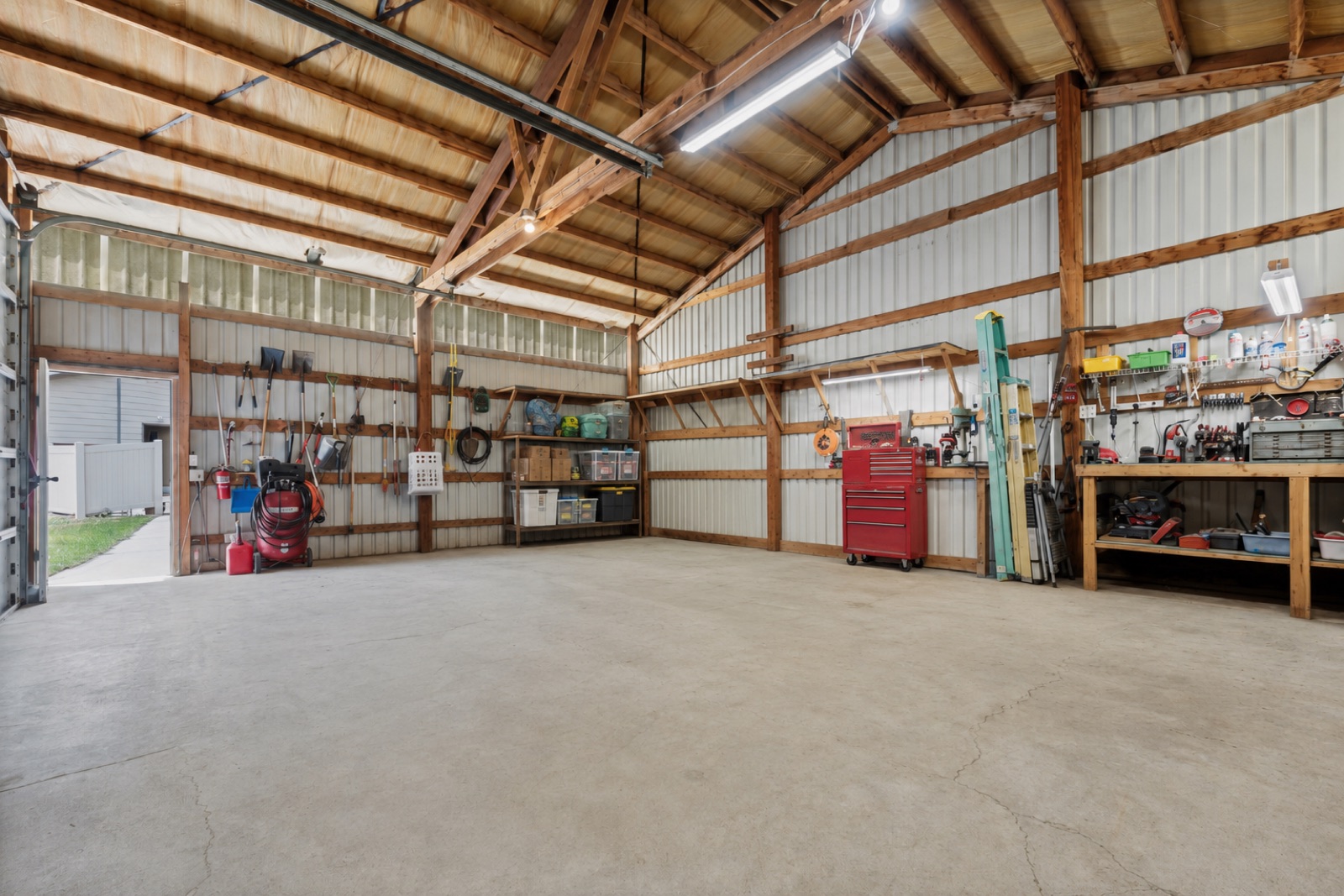 Open shop interior with concrete floor and tool storage